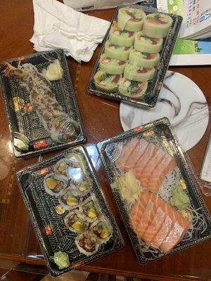 From top-left clockwise: Shrimp Tempura Roll, Fish Naruto Roll, Sashimi, and Eel Avocado Roll