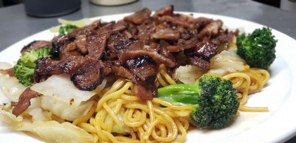 Pork Teriyaki, featuring thin slices of marinated pork on a bed of steamed vegetables and egg noodles.