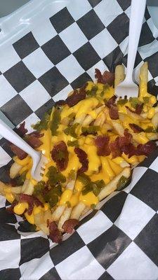 try our loaded fries! lightly salted, nacho cheese, bacon, and jalapeño peppers.