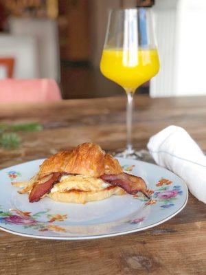 Soft scrambled farm egg with thick cut bacon, comté and a house mimosa