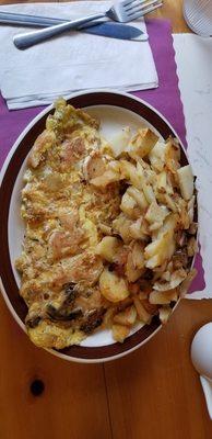 Stefani Omelet with home fries with fried onions.