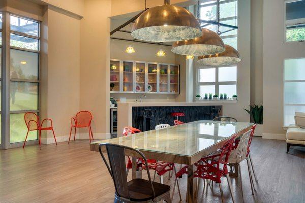 Clubhouse with hardwood style flooring, high ceilings, fireplace, and kitchen.