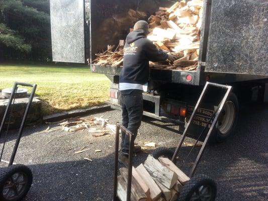 Unloading some our firewood for a delivery.