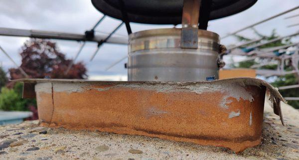 Chimney cap should cover the outside of the chimney tile, not lay flat on it.