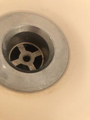 Dirt around drain in bathtub