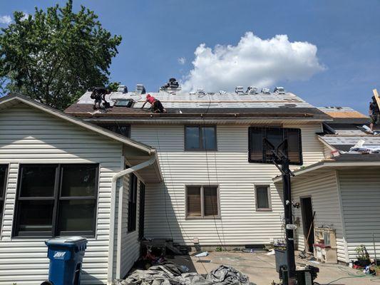 The Zups Construction Crew roped off and installing a new roof.