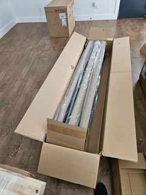 Unpacking and getting ready to assemble a bed for a client