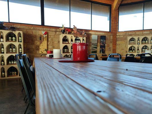 A table in the main hall and some of the wine showcases