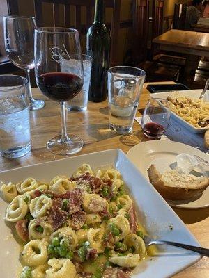 Cheese Tortellini Carbonara and a glass of Reserve Cabernet. Upper right is the Blackened Chicken Alfredo.