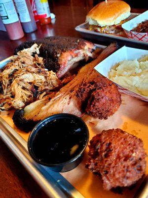 3 meat combo with ribs, brisket, pulled pork.  Sides of smashed potatoes and hush puppies