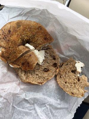 The bottoms of 2 different bagels (one ripped) with a lump of cream cheese. Tough eating while driving!  Just be thorough, NYB employees!