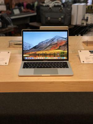 New MacBook Pro 13-inch with Touch Bar on display.