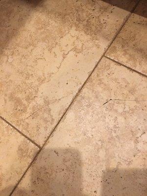 Tile and grout both cracking, floor not installed level and grout continues to dissipate in other areas of floor