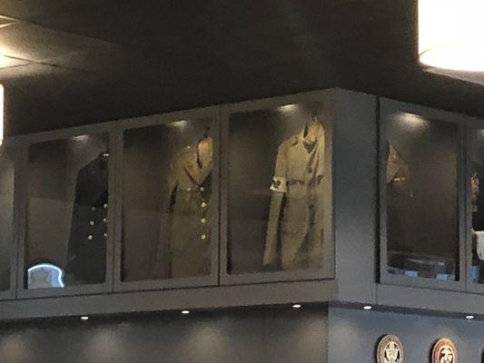 Vintage uniform displays above bar