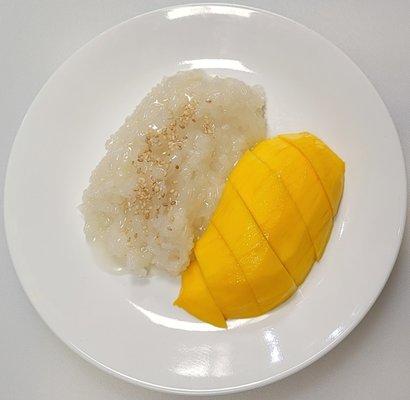 Mango Sticky Rice: Sliced ripe mango served with lightly sweetened creamy coconut sticky rice topped with sesame seeds.