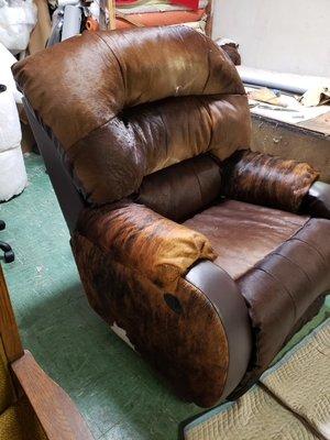 Recliner upholstered in cow hide