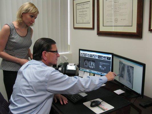 Doctor/Attorney Bob Messey reviewing a client x-ray