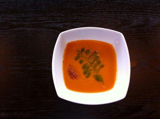 Carrot bisque with basil oil and vegan bacon crumbles