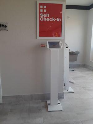 Electronic check in kiosk can be found on your right