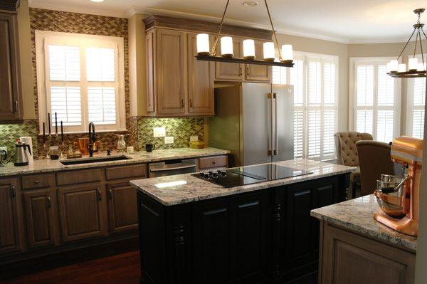 New tile backsplash, new center island, new appliances, new knobs and pulls, glazed cabinets, new granite & new lighting.