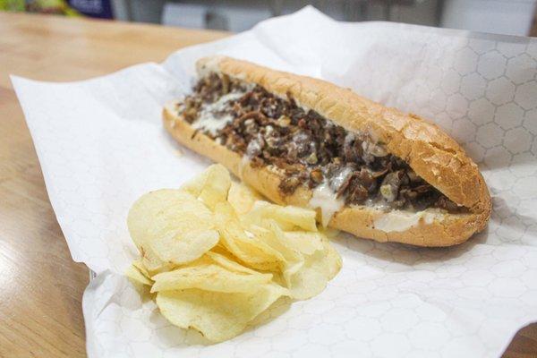 Cheesesteak with chips on the side. Delicious!