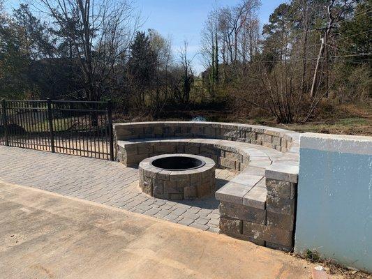 This is the finished product of installing customer retaining wall bench made of blocks, firepit and pavers area poolside.