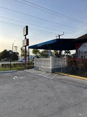 Patio from the parking lot. My dog and I walk up the ramp by the fence and directly to the outdoor window to order