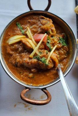 Chicken Curry under the Indian Specialties menu section. Tender chicken in a medium spicy super flavorful curry. Fantastic