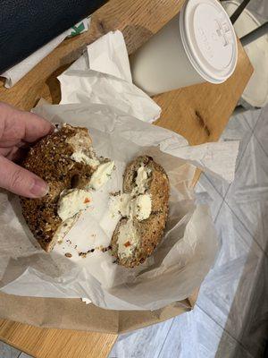 Multigrain bagel with olive cream cheese