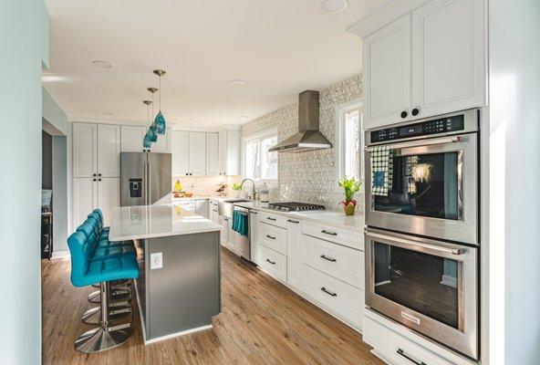 Kitchen remodel in Centreville, VA with wooden flooring and hooded chimney