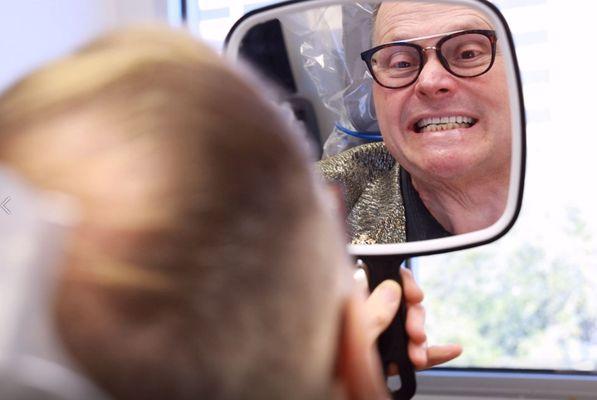 Nuvia Dental Implant Center Patient Admiring His New Teeth