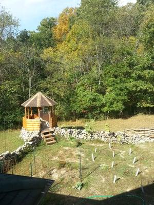 Side of house of gazebo and garden. Taken during the fall, the foliage is beautiful.