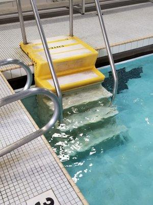 Dirty stairs leading into the pool