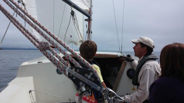 Captain Steve guiding the Little One at the helm.