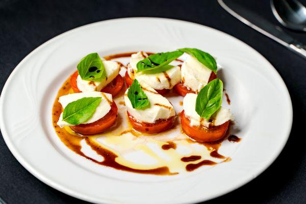 Caprese Salad, Locally grown tomatoes, Fior di latte mozzarella, Fresh basil, topped with Olive oil and Fig balsamic