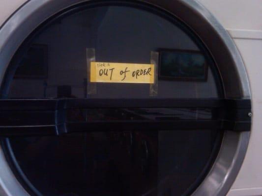 Just one of many lovely "out of order" signs you'll see at this laundromat.