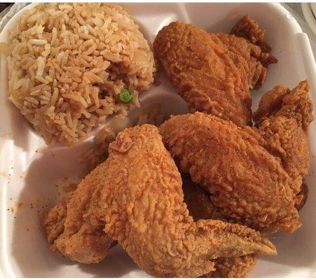 Chicken wings with fried rice.