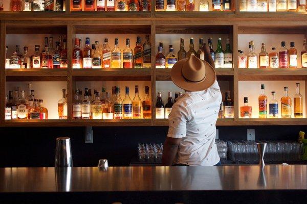 A bartender picking a whisky.