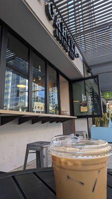 Small outdoor seating area and walk-up window. Good Coffee