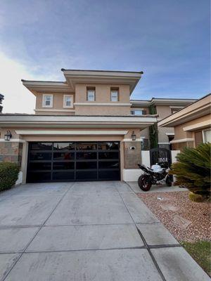 Full view garage door: 16'0 X 7'0 EL100. Dark bronze anodized. 1/4" black laminate glass.