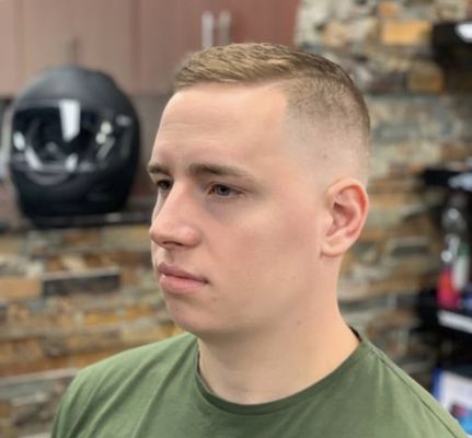 Mid skin-fade with a natural-parted combover for a clean look