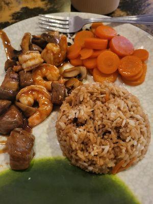 Steak and shrimp lunch with carrots and pilaf