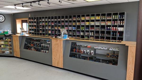 Our wall of E-liquid and Salt Nic with our cases of mods/tanks/kits