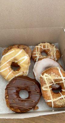 Nutella Glazed Donut, Cinnamon Crunch Donut, Vanilla Bean Glazed Donut, signature donut orange cream, Caramel Espresso Donut.