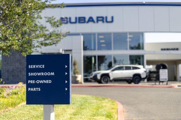 directional sign in front of Elk Grove Subaru Dealership serving Sacramento