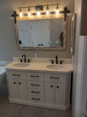 Mirror, light fixture, and countertop faucet install.