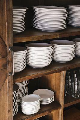 Rich woodwork, crisp dinnerware, and bountiful daylight in our dining room.