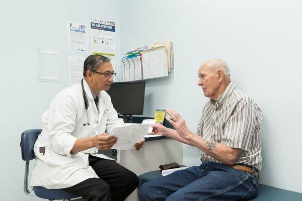 Dr. Aurelio Muyot listens as his patient describes his symptoms.