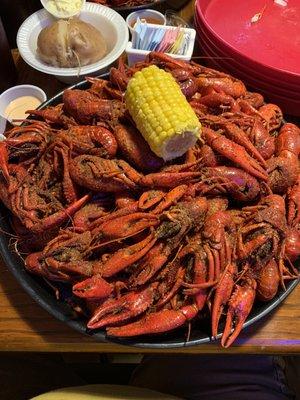 5lbs of boiled crawfish with a potato and corn