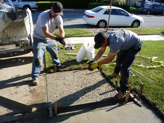 Unbelievable! They are matching the aggregate from installed 25 years ago by "seeding" the new aggregate by hand.